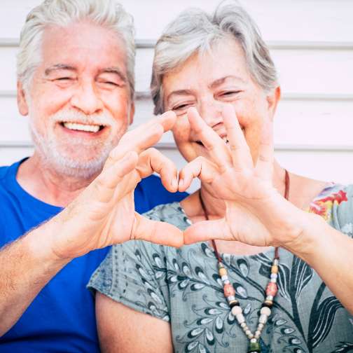 Senior making heart with hands